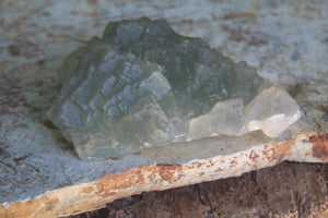 Raw Mongolian Fluorite (cosmic city) by Bahgsu Jewels features translucent green and white cubic crystals on a rough stone base, prized for aura cleansing and powerful healing.
